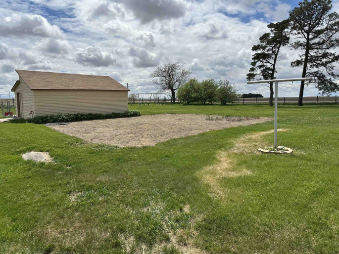 and large fenced in yard with garden area