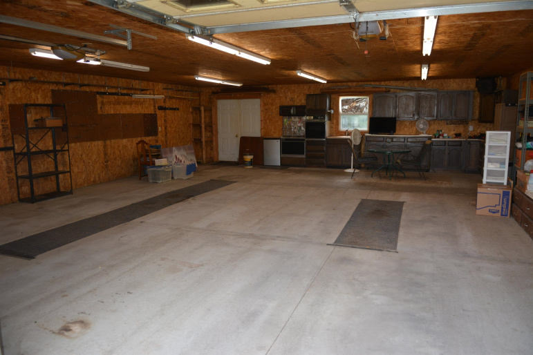 The back wall of the garage has double doors, so a riding mower can roll right in!